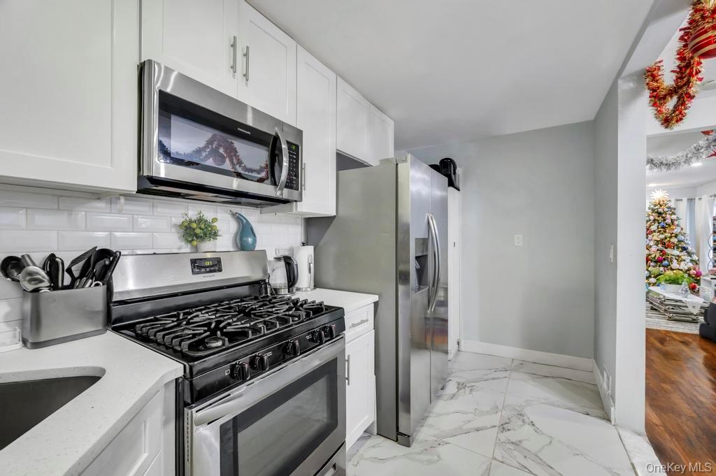 178-26 Zoller Road Queens, NY 11434 - Photo 13 of 26 a kitchen with a stove and a refrigerator