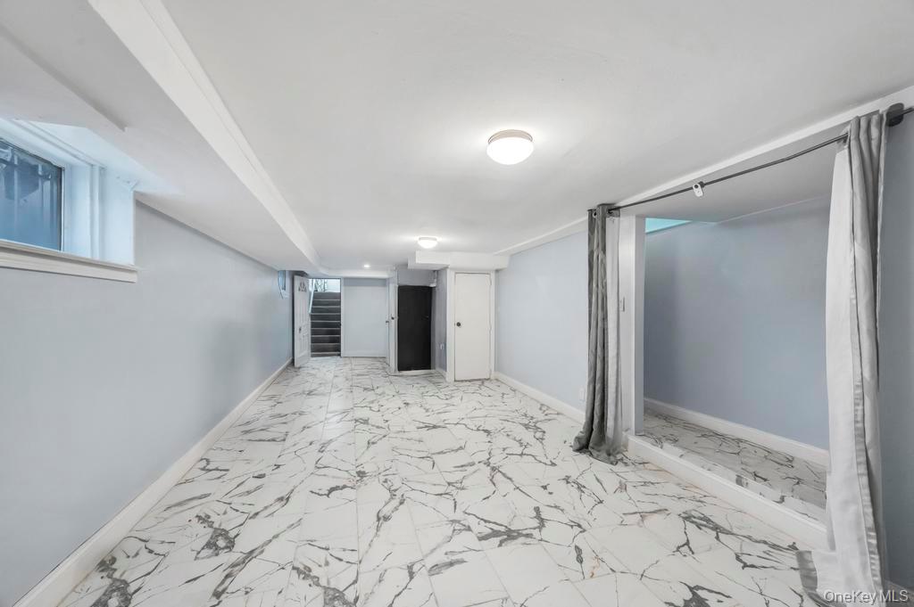 178-26 Zoller Road Queens, NY 11434 - Photo 16 of 26 a view of a big room with wooden floor and a hallway