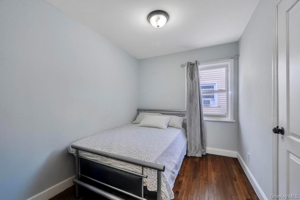 178-26 Zoller Road Queens, NY 11434 - Photo 22 of 26 a bedroom with a bed and a table