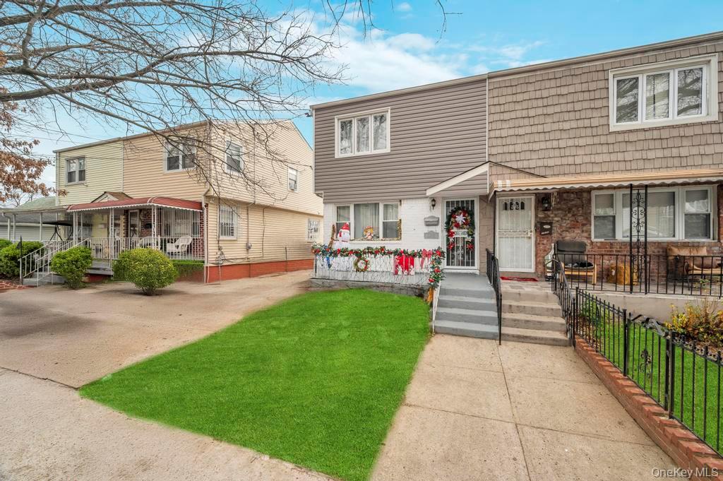 178-26 Zoller Road Queens, NY 11434 - Photo 3 of 26 a front view of a building with a garden and plants