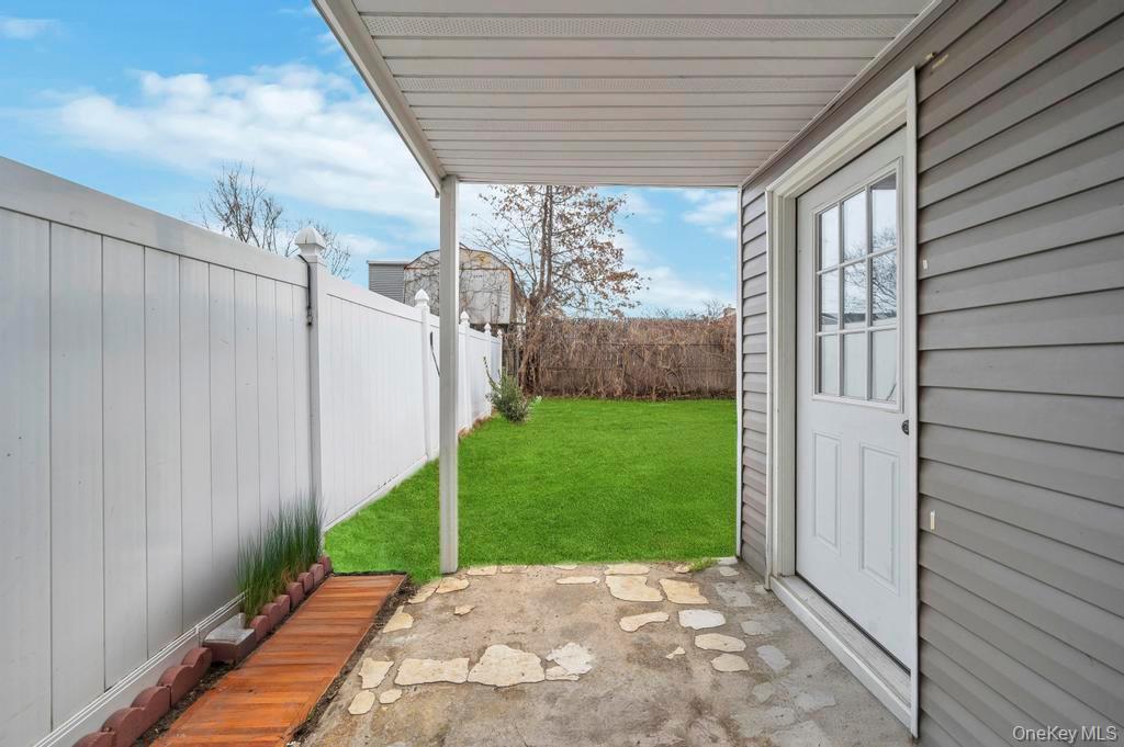 178-26 Zoller Road Queens, NY 11434 - Photo 5 of 26 a view of backyard with plants and wooden fence