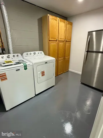 a view of a room with wooden walls and furniture