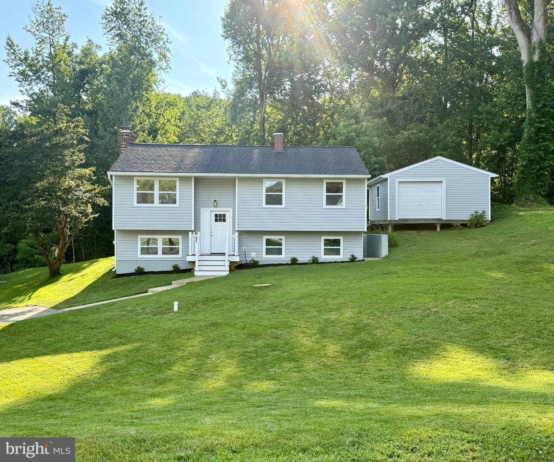 3600 4th Street North Beach, MD 20714 - Photo 2 of 32 a view of a house with a big yard and large trees