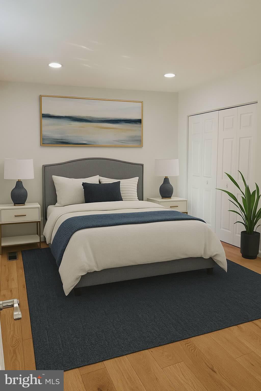 3600 4th Street North Beach, MD 20714 - Photo 21 of 32 a bedroom with a bed and a potted plant