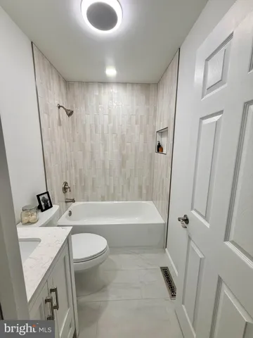 a bathroom with a sink a toilet and a bathtub