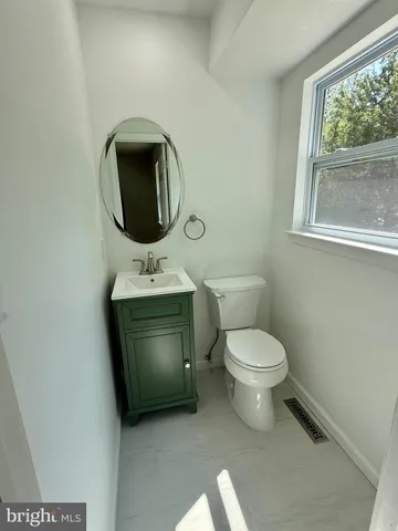a bathroom with a toilet sink and window