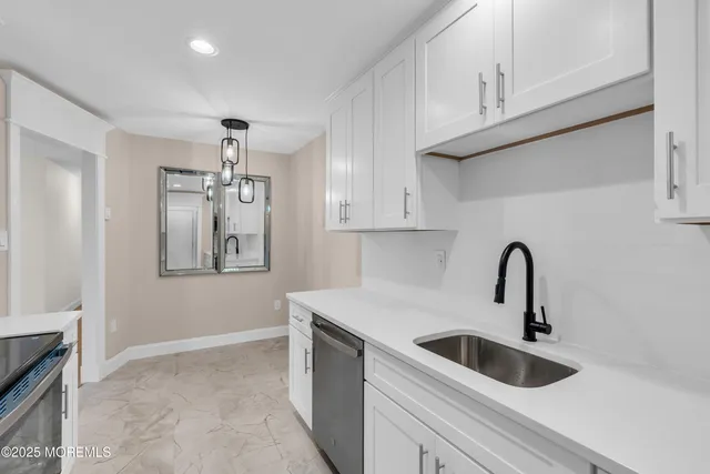 a kitchen with a sink and cabinets