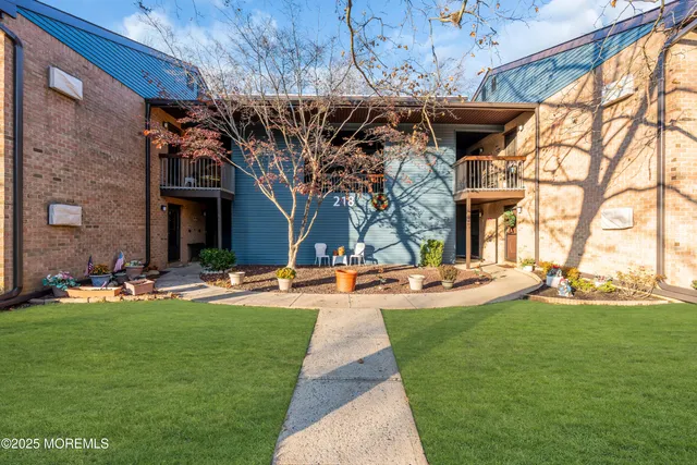 a view of a backyard with table and chairs under an umbrella