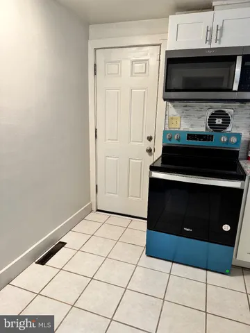 a kitchen with a stove and a cabinet