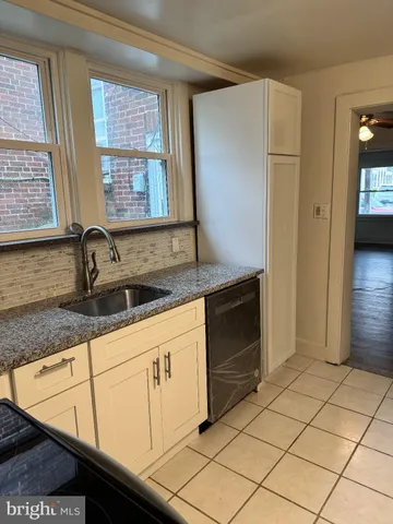 a kitchen with granite countertop a sink and a stove top oven