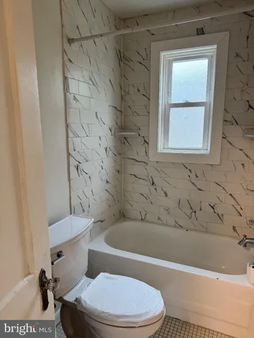 a bathroom with a toilet and a bathtub