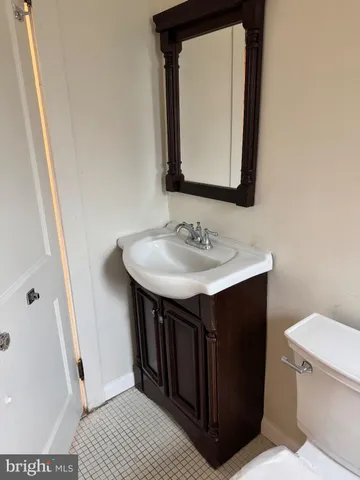 a bathroom with a sink vanity and a toilet
