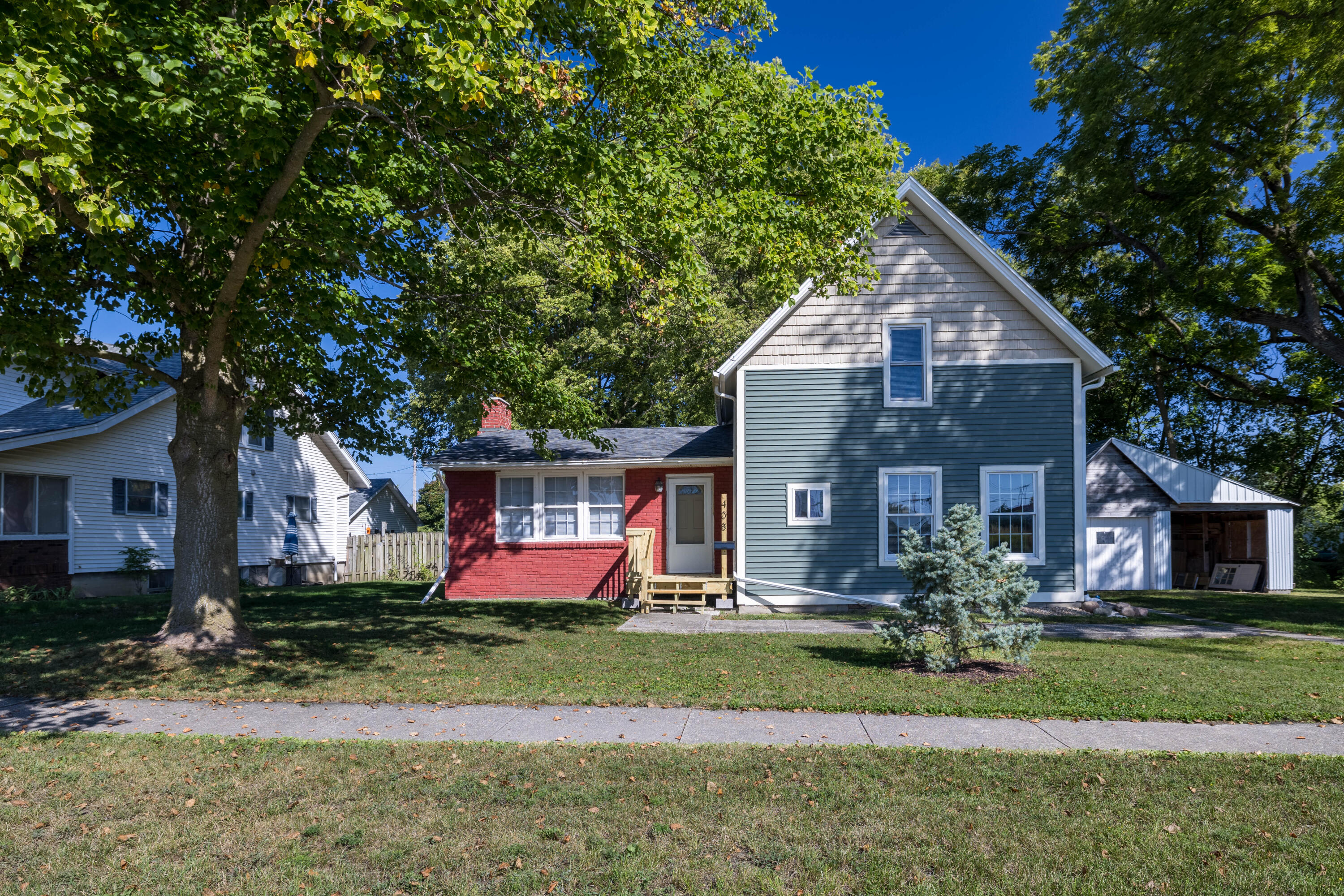 a front view of house with yard and green space