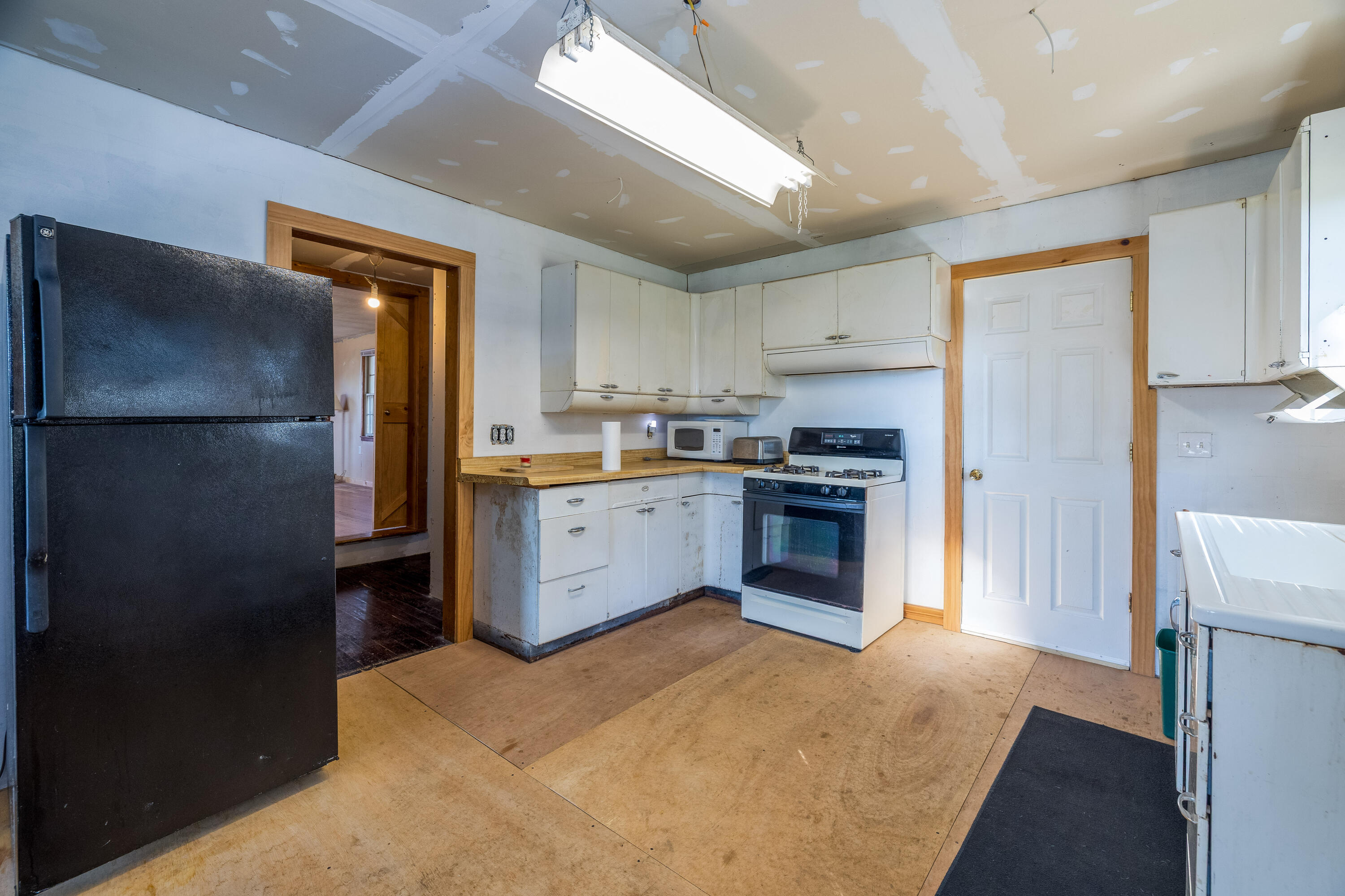 408 East Graham Street Kentland, IN 47951 - Photo 13 of 30 a kitchen with a refrigerator sink and cabinets