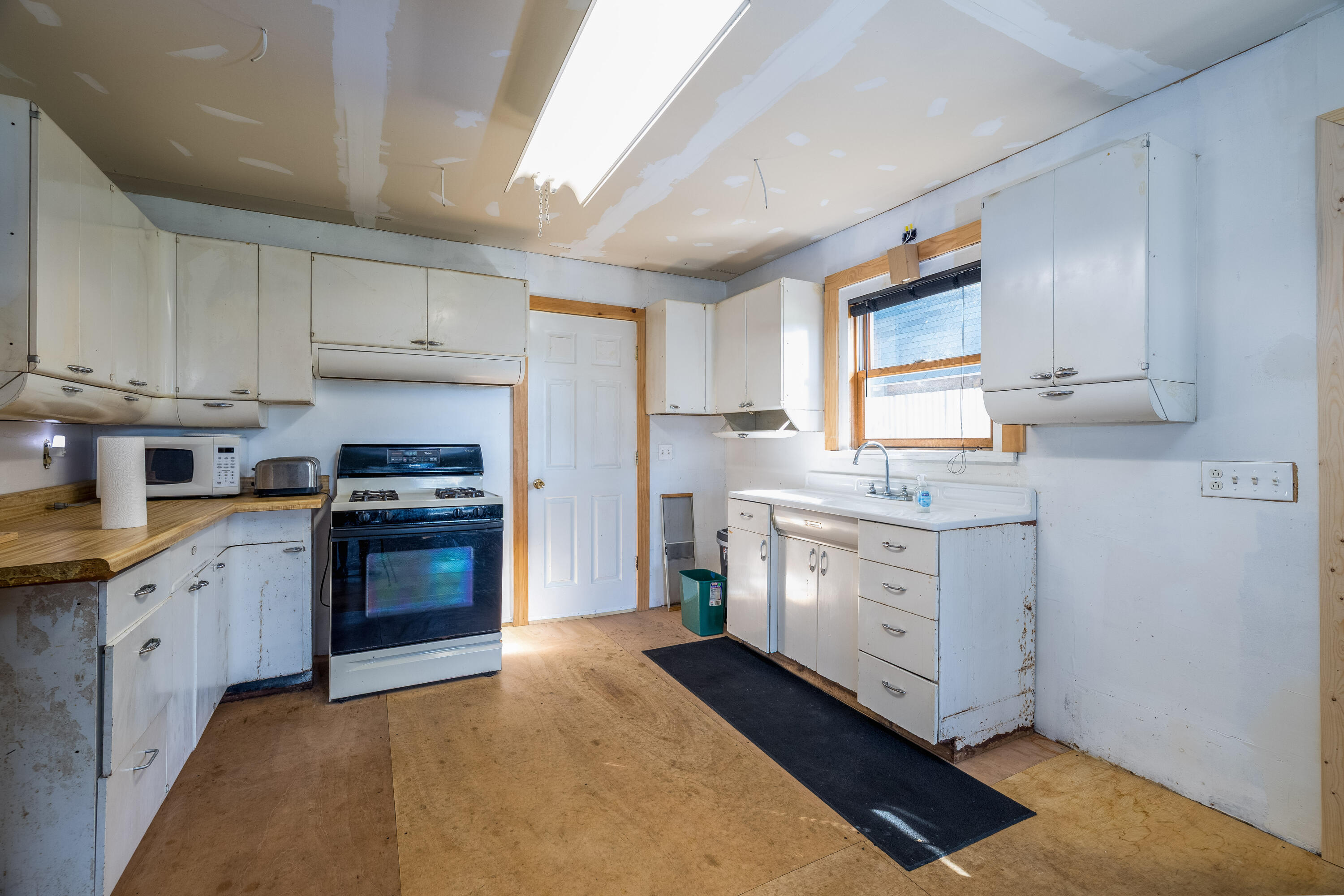 408 East Graham Street Kentland, IN 47951 - Photo 14 of 30 a kitchen with granite countertop white cabinets and stainless steel appliances