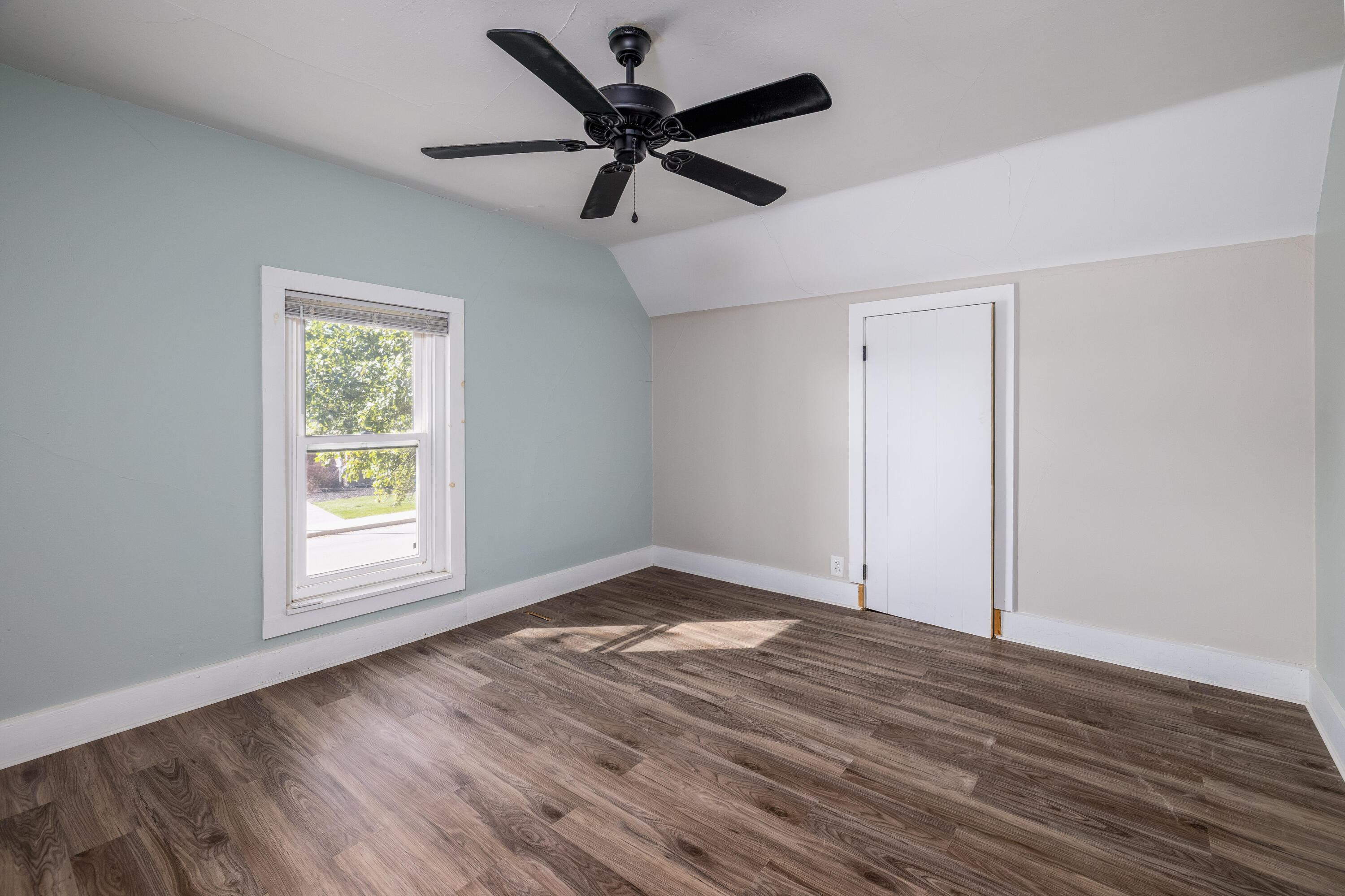 408 East Graham Street Kentland, IN 47951 - Photo 24 of 30 an empty room with wooden floor fan and windows