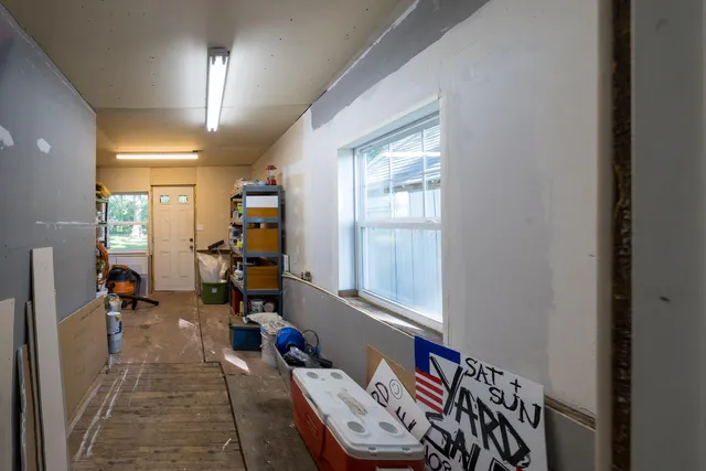 a living room with furniture a window and a flat screen tv