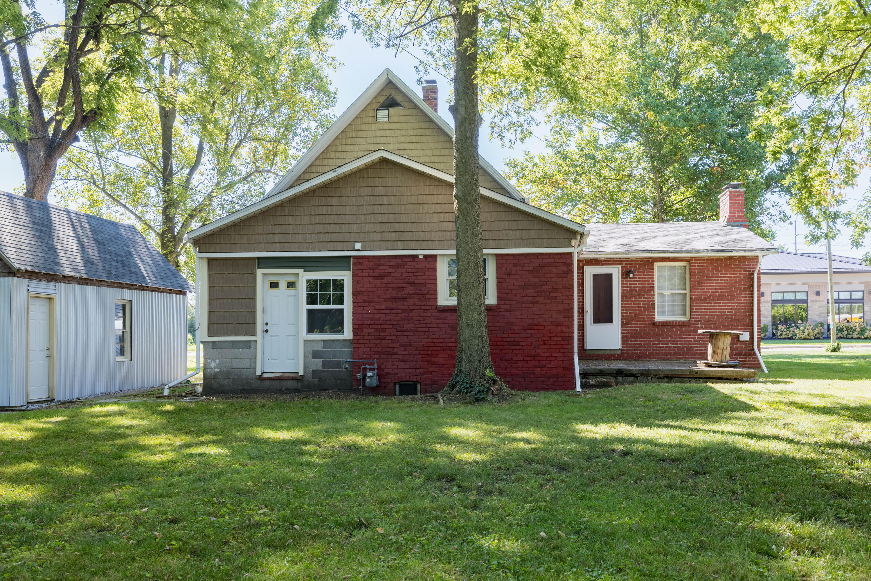 408 East Graham Street Kentland, IN 47951 - Photo 6 of 30 a view of a yard in front of a house with large tree