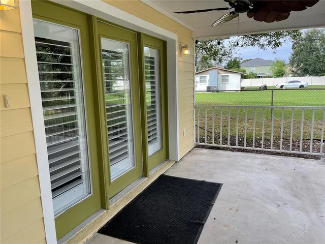 a view of a balcony with floor to ceiling windows