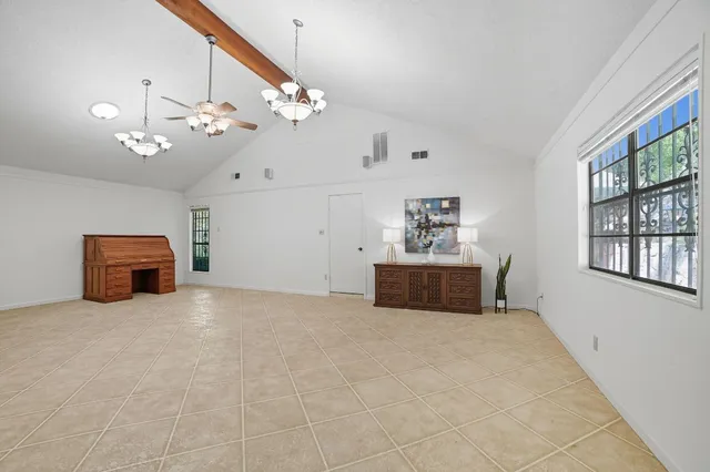 a view of a livingroom with a chandelier furniture and windows