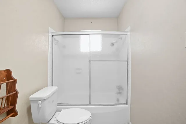 a white toilet sitting next to a bathroom sink
