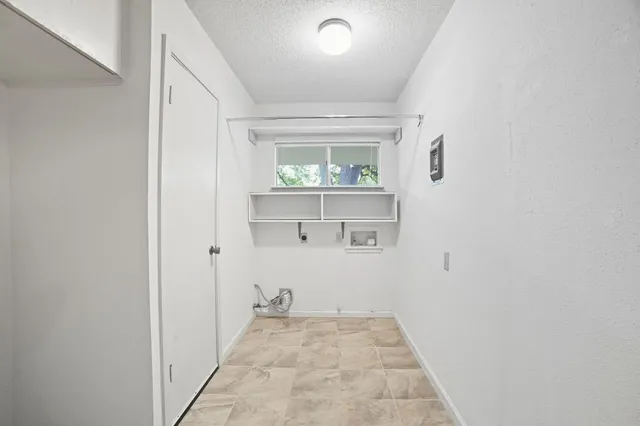 a view of a house with wooden fence