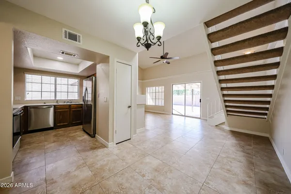 a kitchen with stainless steel appliances granite countertop a stove a sink and a refrigerator