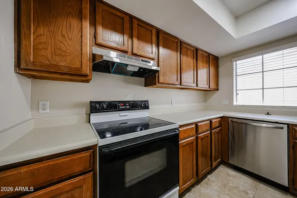 a kitchen with a sink cabinets and window