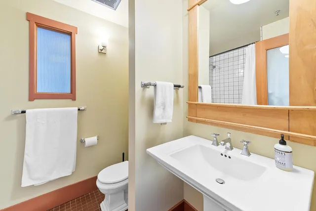 a bedroom with a bed and a large mirror