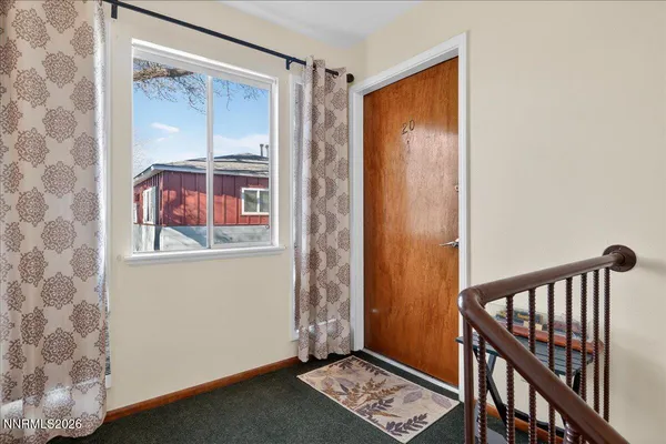 a view of front door with wooden floor