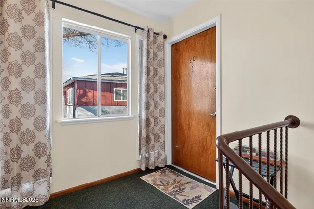 a view of front door with wooden floor