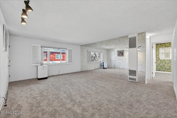 a view of a big room with windows and closet