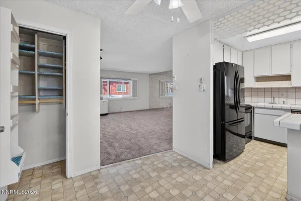 a view of kitchen with refrigerator and window