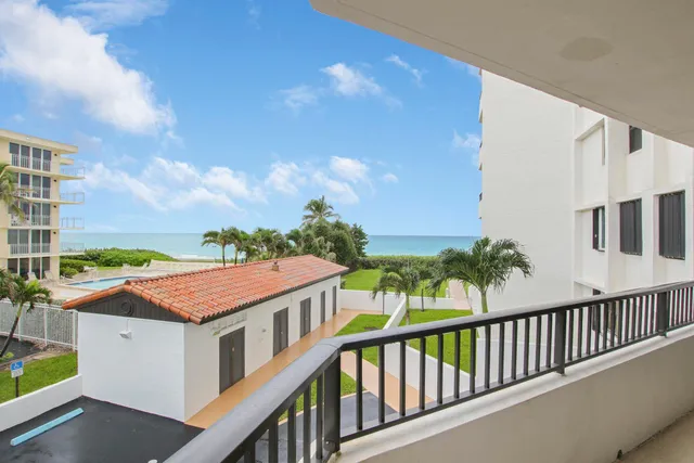 a balcony with a table and chairs