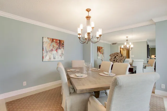 a view of a dining room with furniture and chandelier
