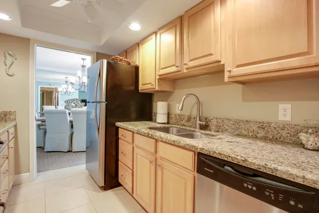 a kitchen with a sink appliances and cabinets