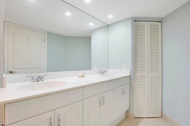 a bathroom with a sink double vanity and a mirror