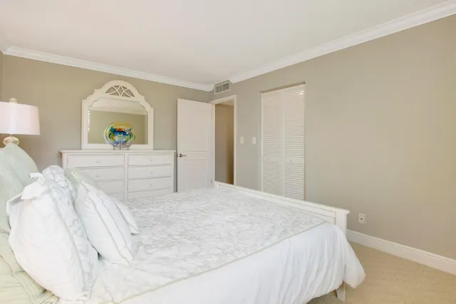 a bedroom with a bed and painting on the wall