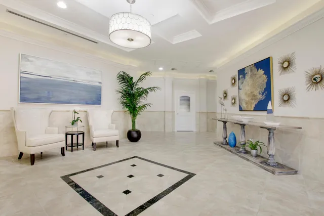 a lobby with furniture and a potted plant