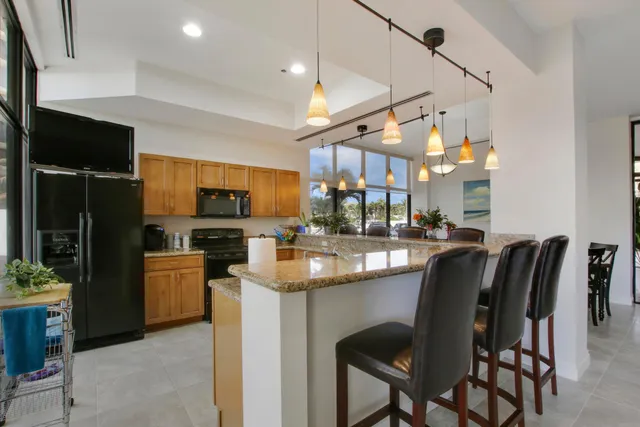 a dining room with furniture potted plants and wooden floor