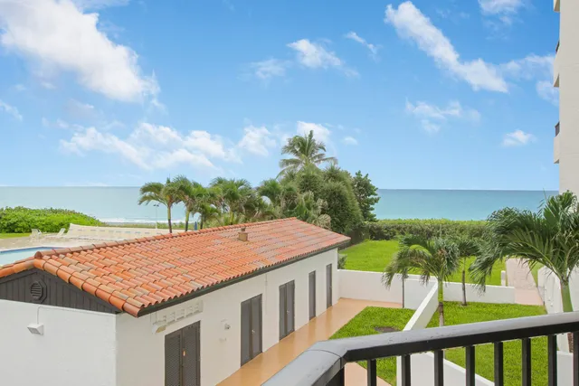 a view of a terrace with a table and chairs