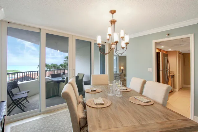 a view of a dining room with furniture wooden floor and chandelier
