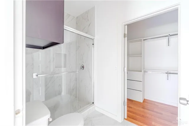 a bathroom with a shower and a toilet