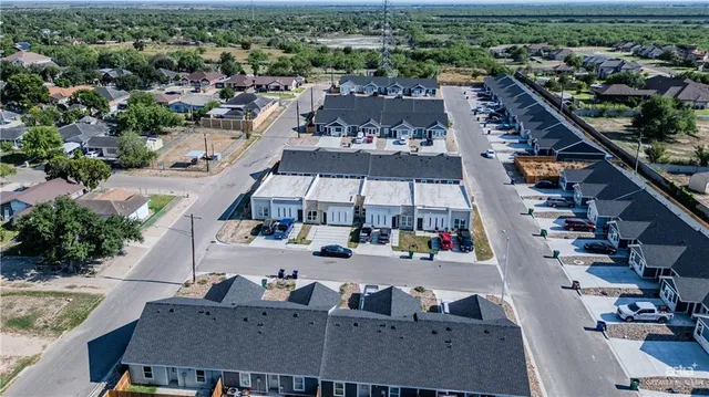 an aerial view of multiple houses with yard