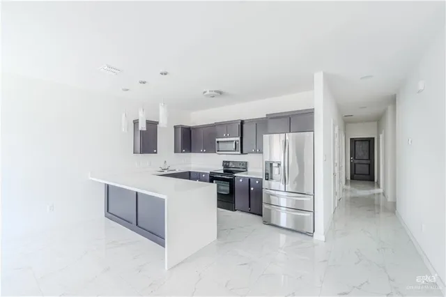 a kitchen with stainless steel appliances a refrigerator and a stove