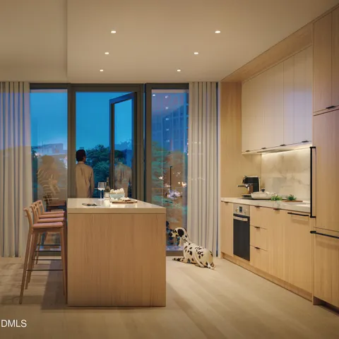 a living room with stainless steel appliances granite countertop furniture and a kitchen view