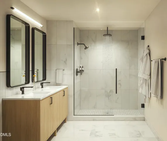 a bathroom with a granite countertop sink mirror and shower