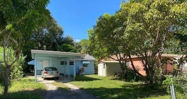 a view of a house with sitting area and garden