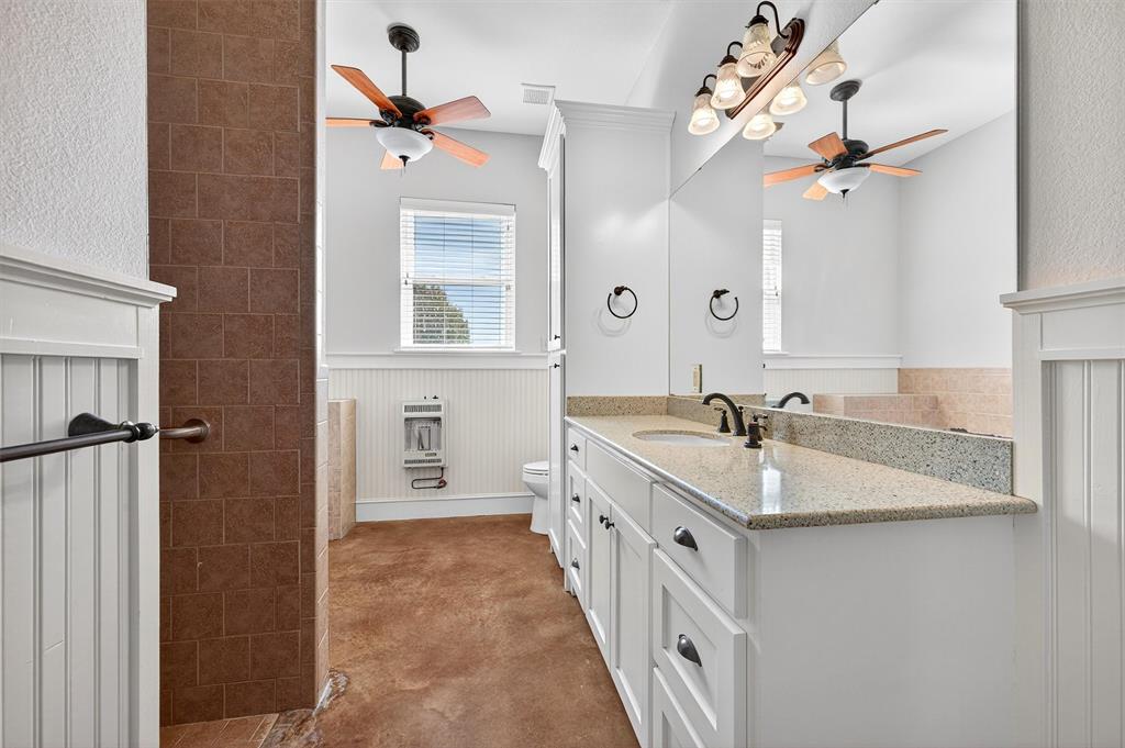 2166 Old Southmayd Road Sherman, TX 75092 - Photo 26 of 40 a bathroom with a double vanity sink a mirror and a shower