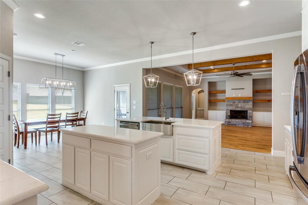 14717 Lost Wagon Street Justin, TX 76247 - Photo 14 of 37 a large white kitchen with a large window